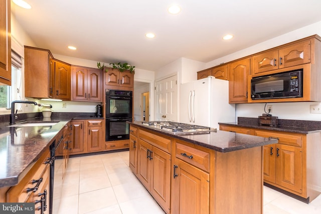 kitchen with black appliances, a sink, a center island, recessed lighting, and light tile patterned flooring