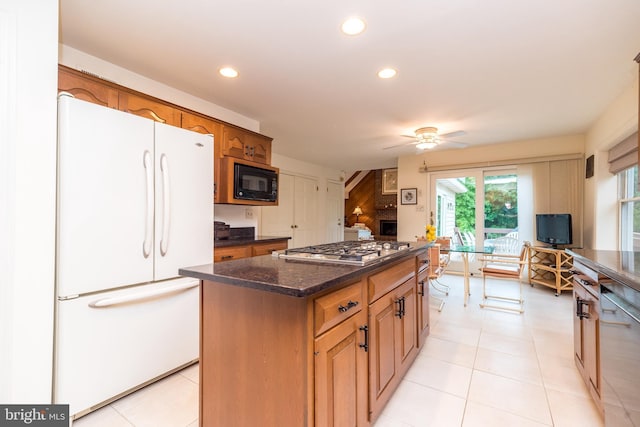 kitchen featuring freestanding refrigerator, stainless steel gas cooktop, black microwave, recessed lighting, and a ceiling fan