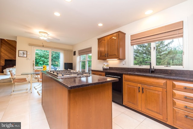 kitchen with dishwasher, a sink, stainless steel gas cooktop, a center island, and recessed lighting