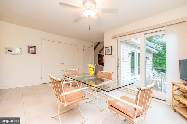 dining room with a ceiling fan and baseboards