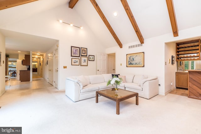 living area featuring light colored carpet, beam ceiling, high vaulted ceiling, recessed lighting, and baseboards
