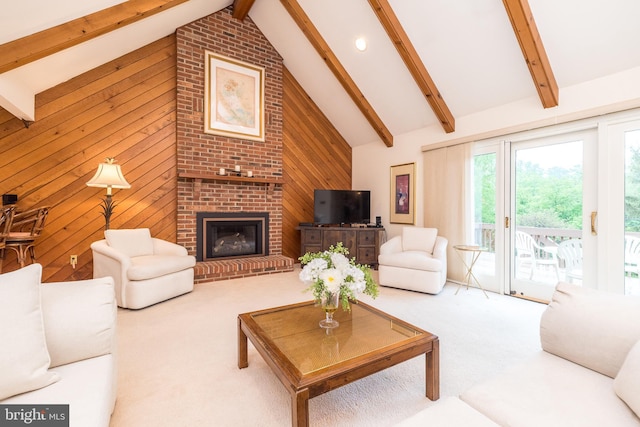 living area with carpet floors, beam ceiling, wood walls, high vaulted ceiling, and a fireplace