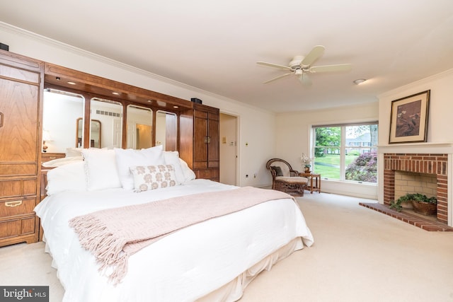 bedroom featuring light carpet, crown molding, a brick fireplace, and a ceiling fan