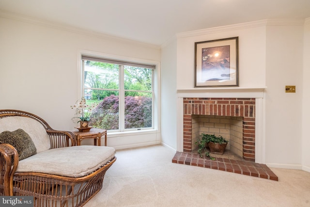 sitting room featuring carpet floors, crown molding, a fireplace, and baseboards