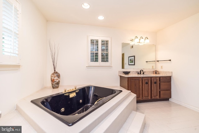 bathroom with a whirlpool tub, vanity, recessed lighting, and tile patterned flooring
