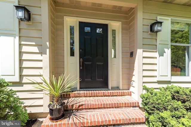 view of exterior entry featuring a porch