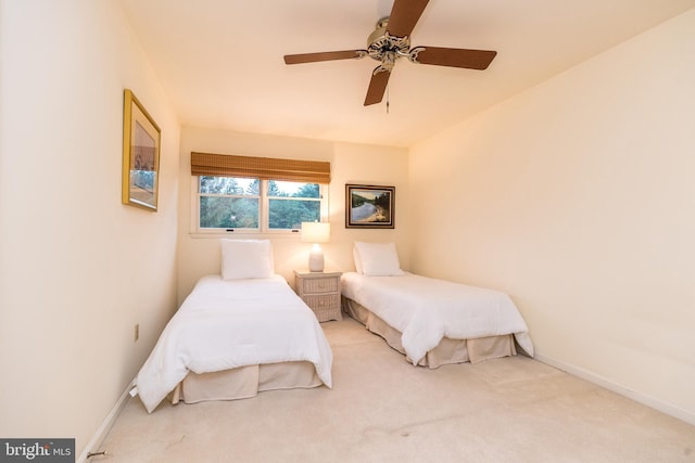 carpeted bedroom featuring baseboards and ceiling fan