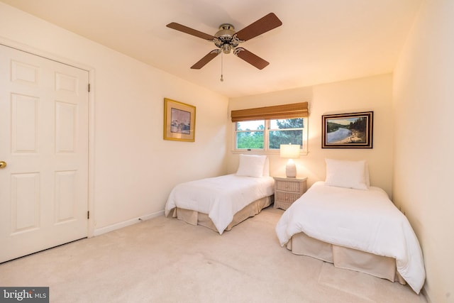 bedroom featuring carpet, baseboards, and a ceiling fan