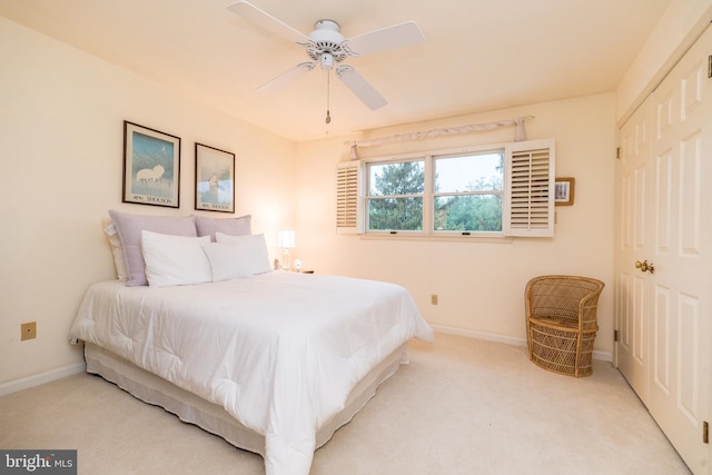 bedroom featuring baseboards, carpet floors, a closet, and ceiling fan