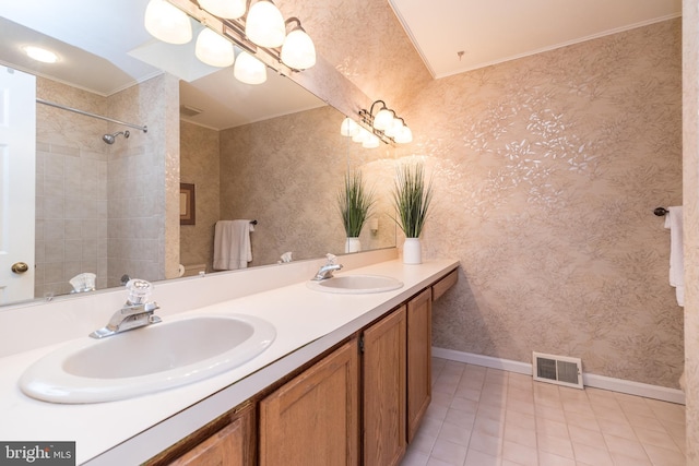 full bath with baseboards, tile patterned floors, wallpapered walls, double vanity, and a shower