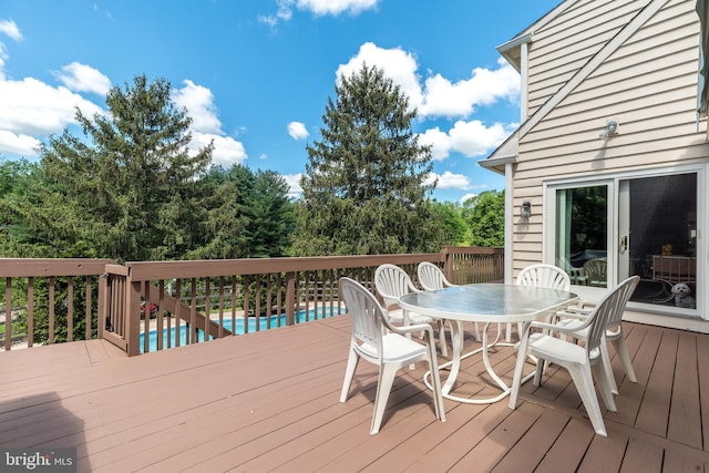 wooden deck featuring outdoor dining space