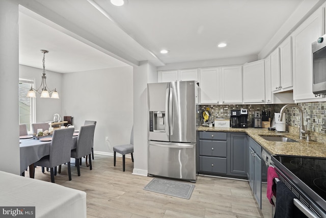 3815 Gawayne Ter Unit 31-381, Silver Spring, MD 20906 - kitchen featuring light stone countertops, gray cabinets, white cabinetry, a sink, and appliances with stainless steel finishes