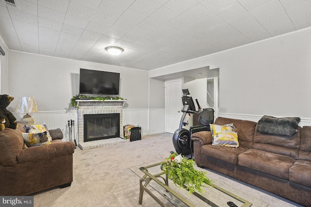 3815 Gawayne Ter Unit 31-381, Silver Spring, MD 20906 - living area featuring crown molding, visible vents, a brick fireplace, a wainscoted wall, and carpet flooring