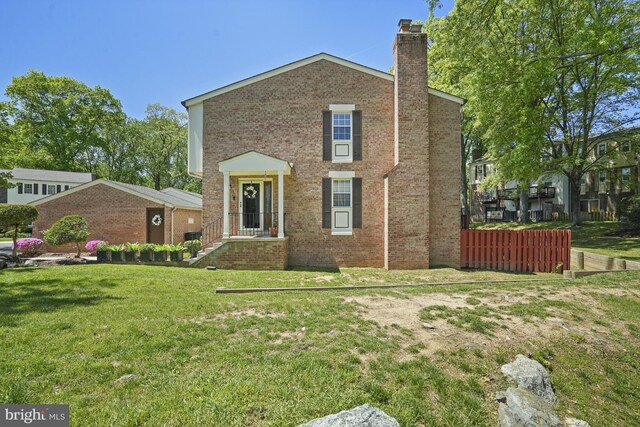 3815 Gawayne Ter Unit 31-381, Silver Spring, MD 20906 - traditional-style home with brick siding, a front yard, and a chimney