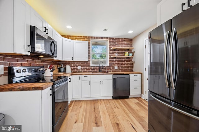 5223 Pentridge St, Philadelphia, PA 19143 - kitchen featuring wooden counters, stainless steel appliances, a sink, white cabinets, and recessed lighting