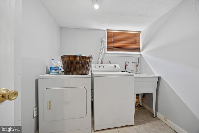 5223 Pentridge St, Philadelphia, PA 19143 - laundry room featuring washer and clothes dryer, tile patterned floors, and baseboards