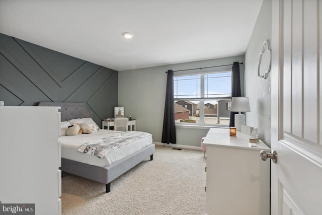 bedroom with light carpet and baseboards