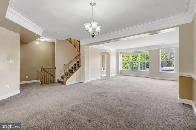 unfurnished living room with crown molding, baseboards, a notable chandelier, and carpet floors