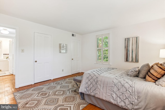 bedroom featuring baseboards and wood finished floors