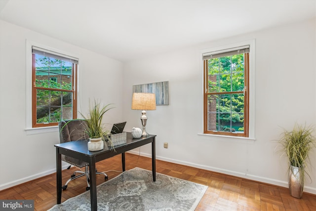 office with baseboards and plenty of natural light