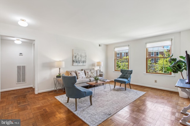 living area featuring baseboards