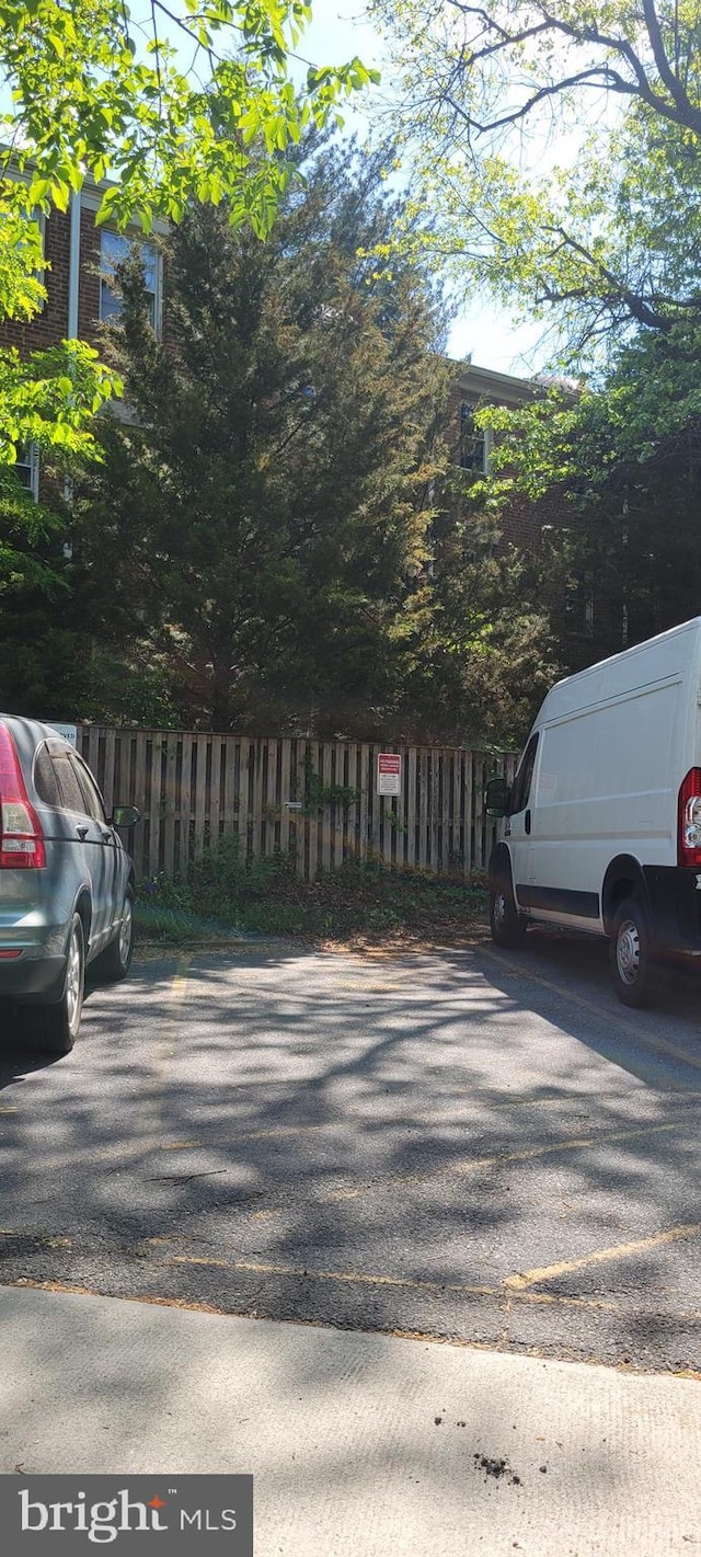 view of parking / parking lot with fence