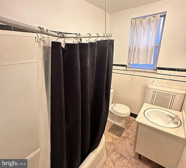 1911 Mckean St, Philadelphia, PA 19145 - bathroom with radiator, vanity, a wainscoted wall, toilet, and shower / tub combo