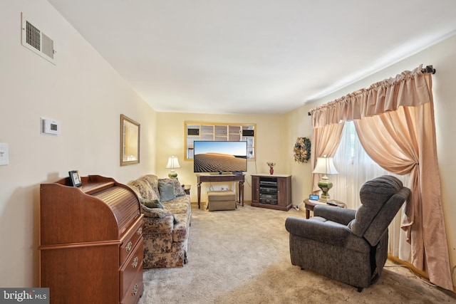 living area with visible vents and carpet flooring