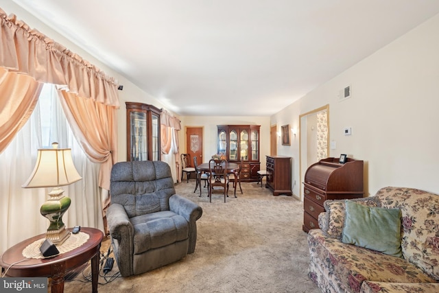 carpeted living room featuring visible vents