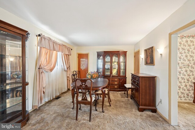 dining space with visible vents and light carpet