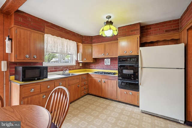 kitchen with light floors, light countertops, a sink, a warming drawer, and black appliances