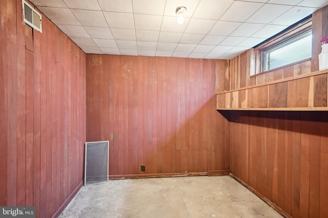 interior space featuring wooden walls and visible vents