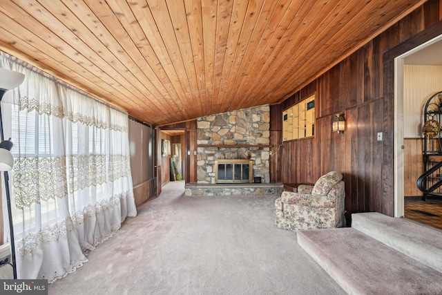 unfurnished living room featuring carpet, wood walls, and wooden ceiling