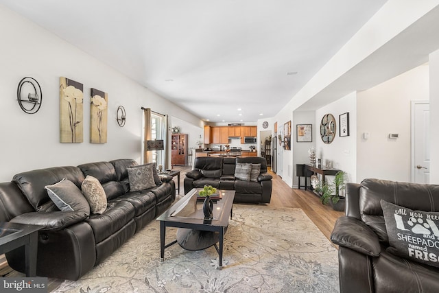 living room with recessed lighting and light wood-style flooring