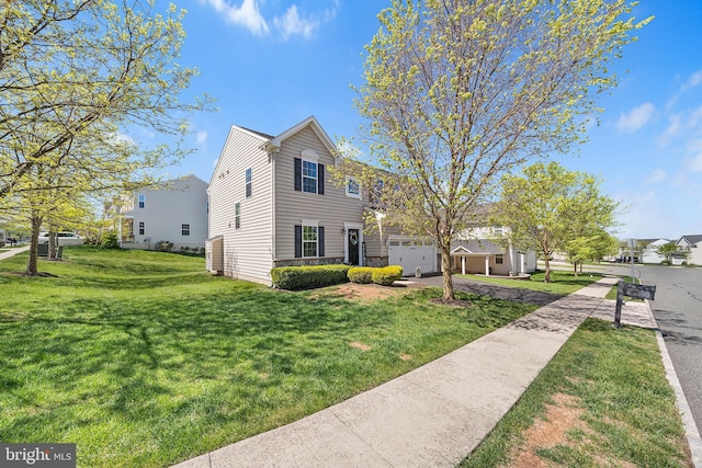 view of front of property featuring a garage and a front yard