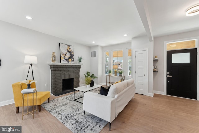 5707 Colorado Ave NW, Washington, DC 20011 - living room featuring wood finished floors, baseboards, a brick fireplace, visible vents, and recessed lighting