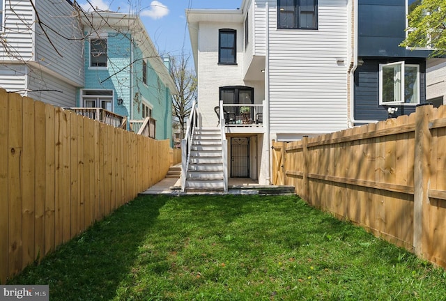 5707 Colorado Ave NW, Washington, DC 20011 - back of property featuring stairs, a lawn, and a fenced backyard