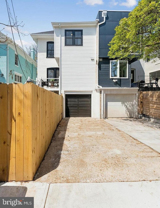 5707 Colorado Ave NW, Washington, DC 20011 - view of front of property featuring concrete driveway, an attached garage, and fence