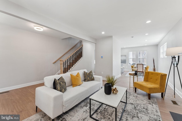 5707 Colorado Ave NW, Washington, DC 20011 - living area featuring light wood-style floors, baseboards, visible vents, and stairs