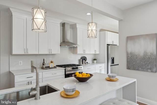 5707 Colorado Ave NW, Washington, DC 20011 - kitchen with white cabinets, stainless steel gas stove, fridge with ice dispenser, wall chimney range hood, and hanging light fixtures