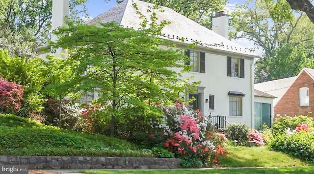 4817 Rodman St NW, Washington, DC 20016 - view of home's exterior with a chimney and stucco siding