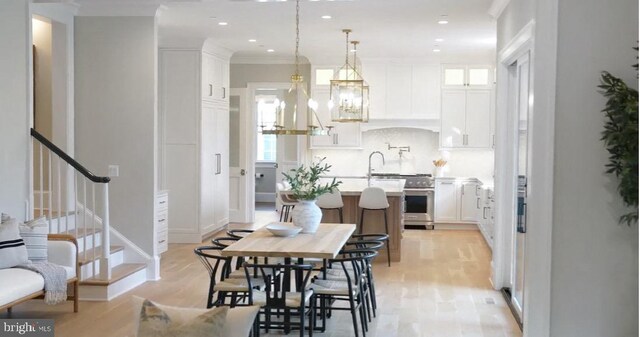 4817 Rodman St NW, Washington, DC 20016 - dining space with light wood finished floors, recessed lighting, stairway, and a chandelier