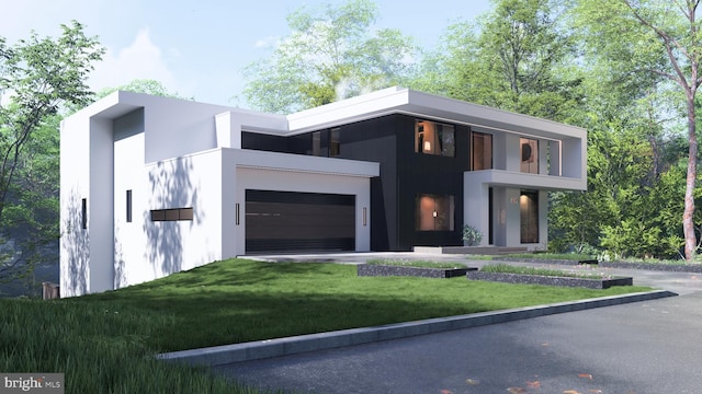 contemporary house featuring a front yard, driveway, stucco siding, and an attached garage