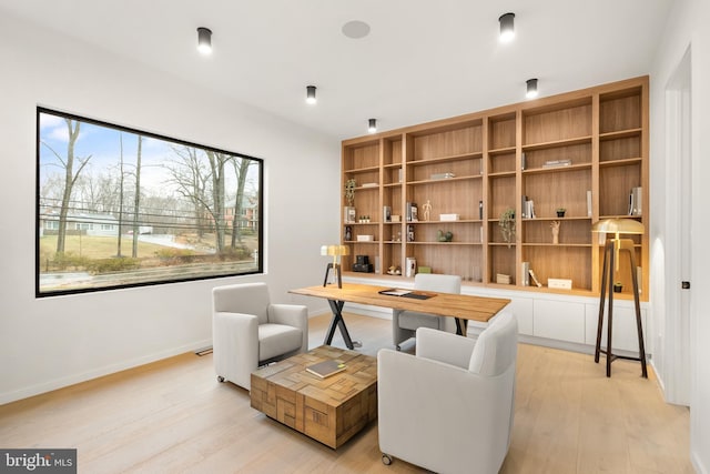 office area with light wood-style flooring and baseboards
