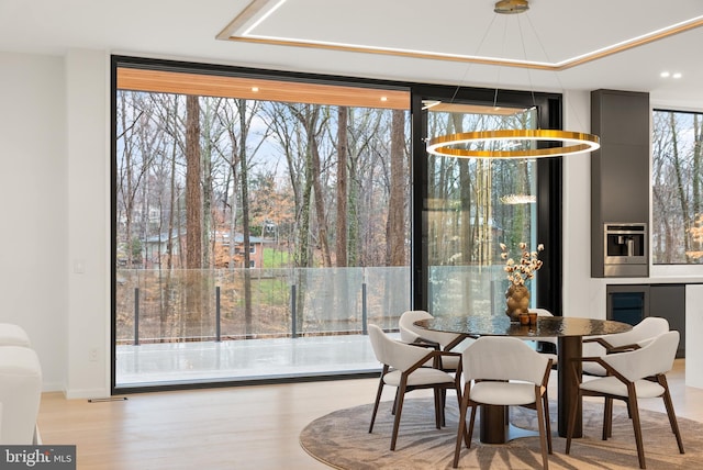 dining room with wood finished floors and expansive windows