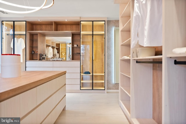 interior space with light wood-style floors and visible vents