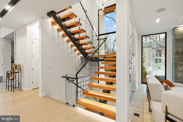stairs with recessed lighting, baseboards, and wood finished floors