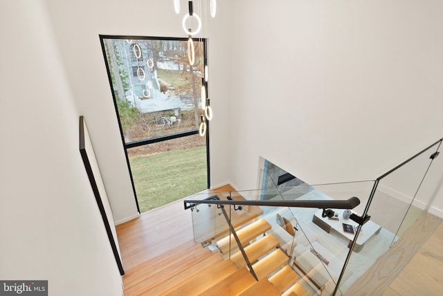 stairway featuring baseboards and wood finished floors
