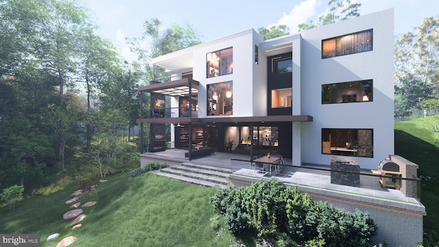 back of property featuring a patio area, a balcony, stucco siding, and a yard