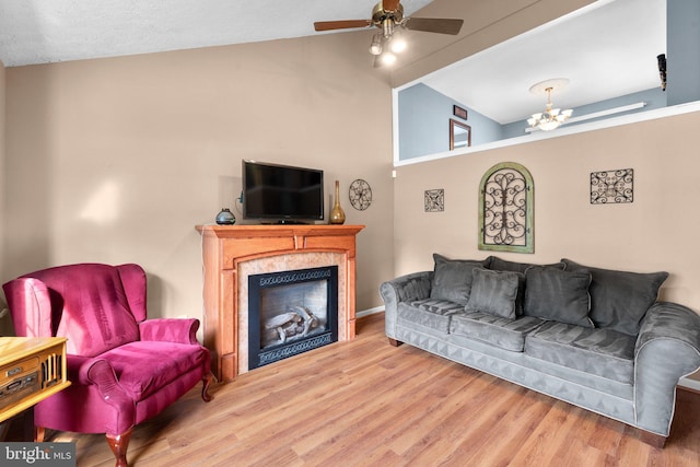 6011 Bauman Dr, Elkridge, MD 21075 - living room with vaulted ceiling, baseboards, ceiling fan with notable chandelier, wood finished floors, and a fireplace